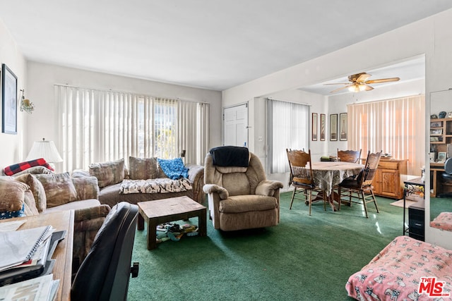 carpeted living room with ceiling fan