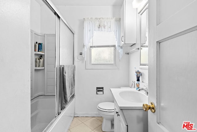 full bathroom with enclosed tub / shower combo, vanity, tile patterned floors, and toilet