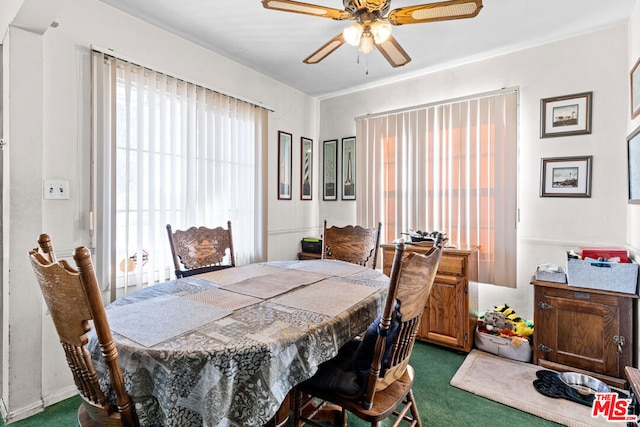 carpeted dining space featuring ceiling fan and a healthy amount of sunlight