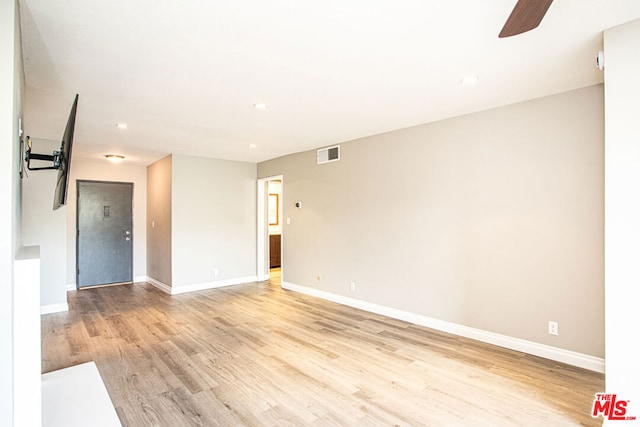 empty room with ceiling fan and light wood-type flooring