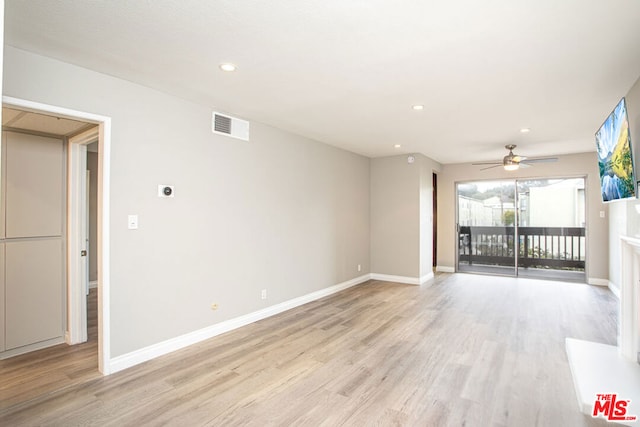 unfurnished living room featuring light hardwood / wood-style flooring and ceiling fan