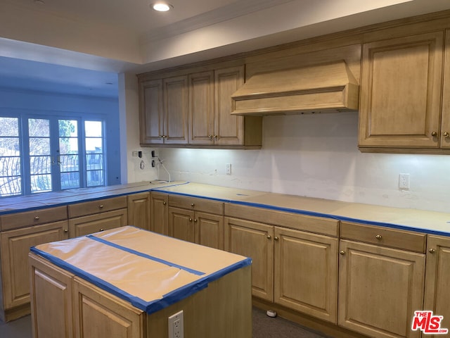 kitchen with premium range hood, stovetop, a center island, and kitchen peninsula