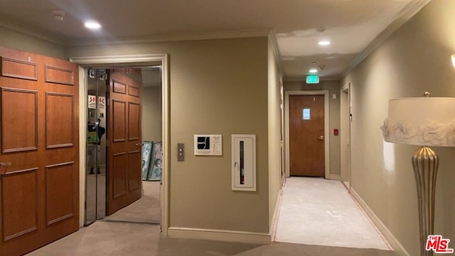 hall featuring crown molding and light carpet