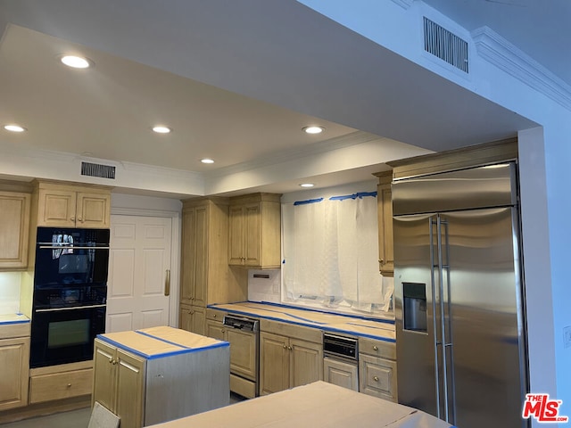 kitchen with paneled dishwasher, tasteful backsplash, built in refrigerator, a kitchen island, and a raised ceiling