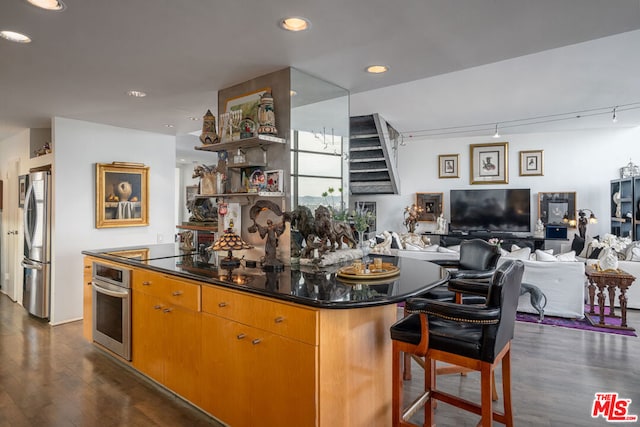 kitchen featuring a center island, dark hardwood / wood-style floors, and appliances with stainless steel finishes