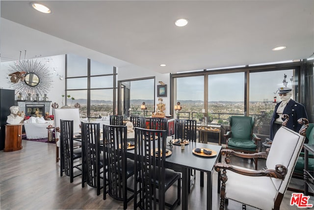 dining area featuring hardwood / wood-style floors and expansive windows