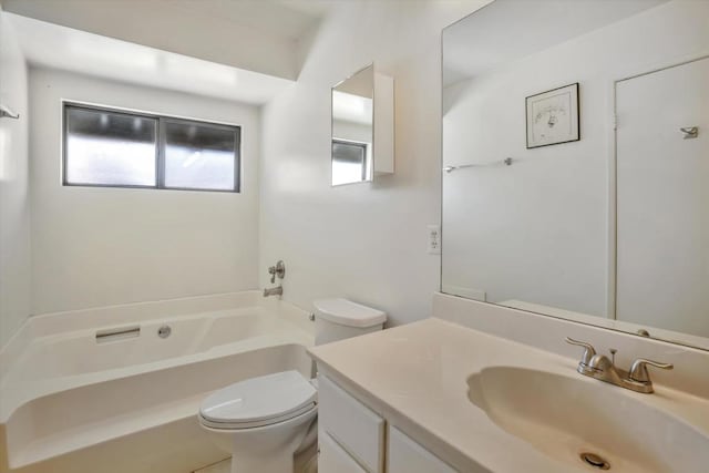 bathroom with toilet, a bath, and vanity