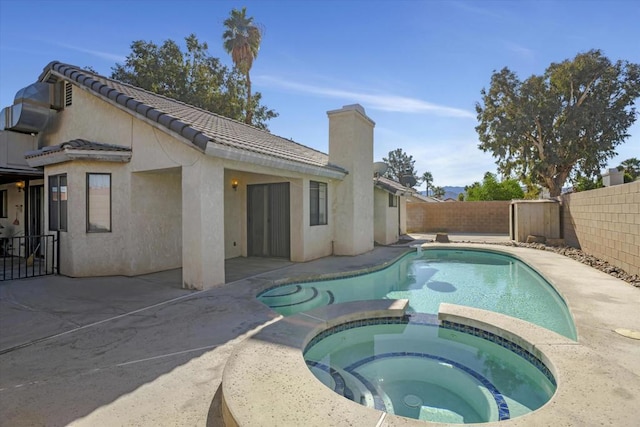 view of swimming pool with a patio area and an in ground hot tub