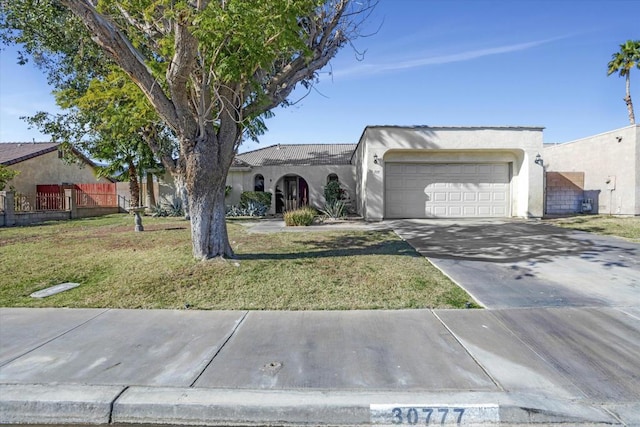 ranch-style house with a front yard and a garage