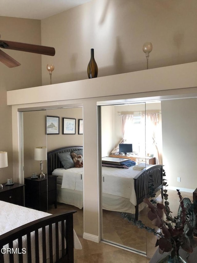 bedroom featuring ceiling fan and a towering ceiling