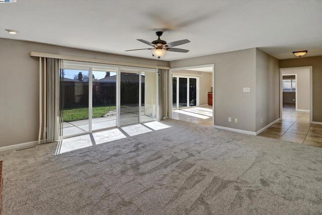 unfurnished room with light colored carpet and ceiling fan