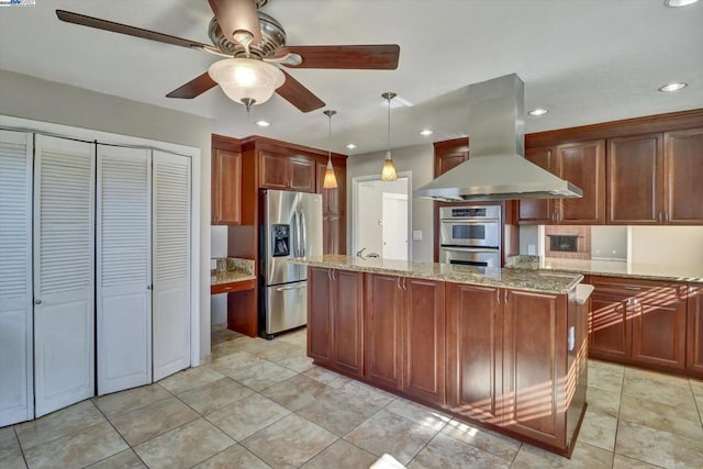 kitchen with light stone countertops, a center island, decorative light fixtures, stainless steel appliances, and island range hood