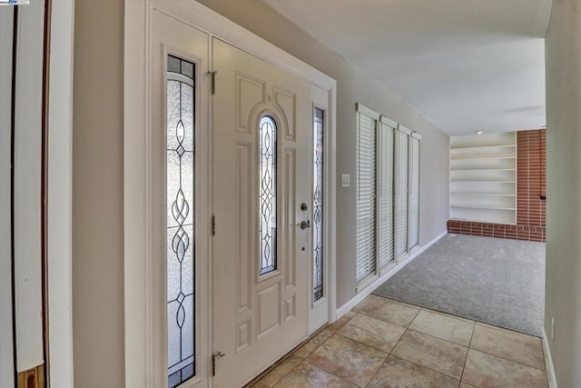 tiled foyer featuring plenty of natural light