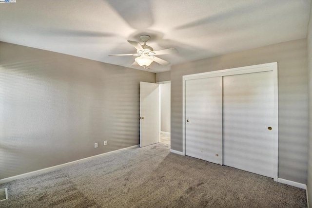 unfurnished bedroom with a closet, ceiling fan, and carpet flooring