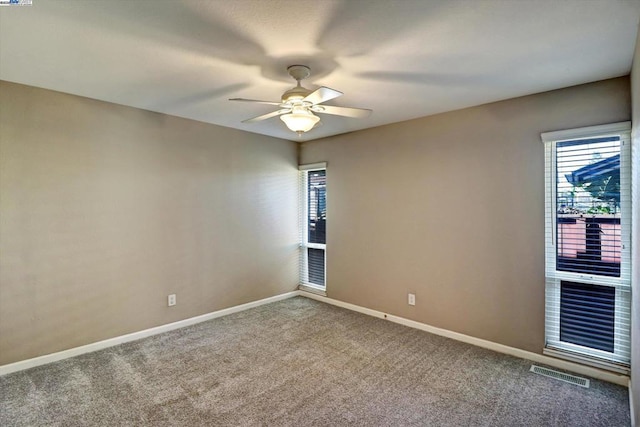 carpeted empty room featuring ceiling fan