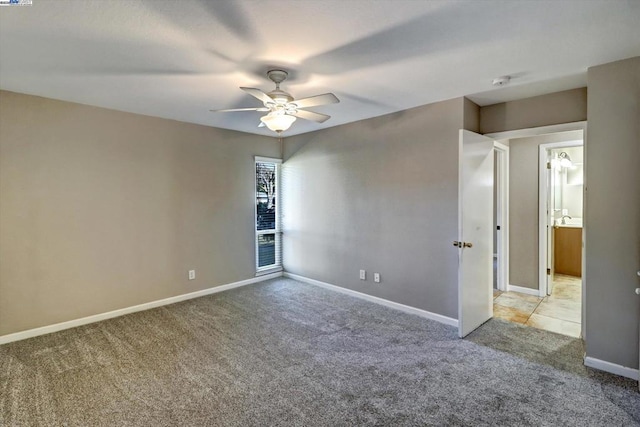 carpeted empty room featuring ceiling fan