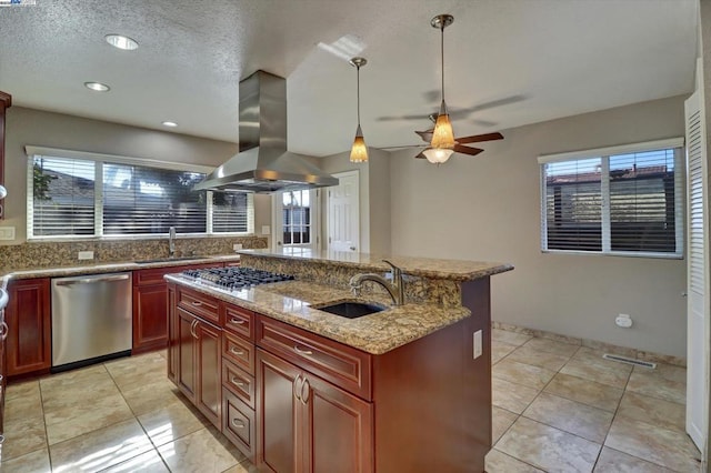 kitchen featuring sink, an island with sink, island exhaust hood, and appliances with stainless steel finishes