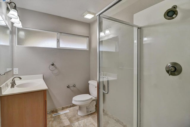 bathroom featuring a shower with door, toilet, and vanity