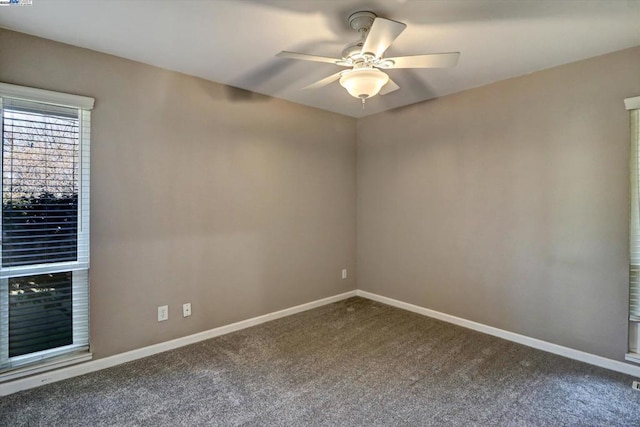 unfurnished room with ceiling fan and carpet flooring