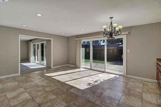 unfurnished dining area with an inviting chandelier