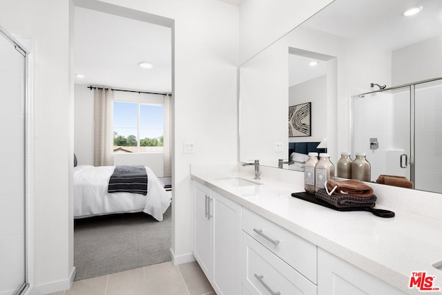 bathroom with tile patterned floors, vanity, and an enclosed shower