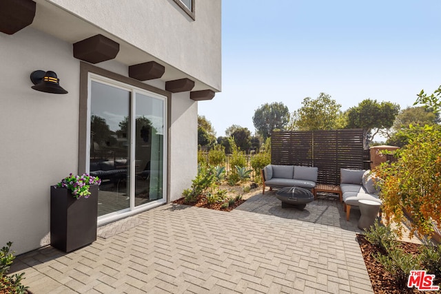 view of patio / terrace featuring an outdoor living space with a fire pit