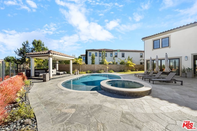 view of pool with a gazebo, a patio, and an in ground hot tub