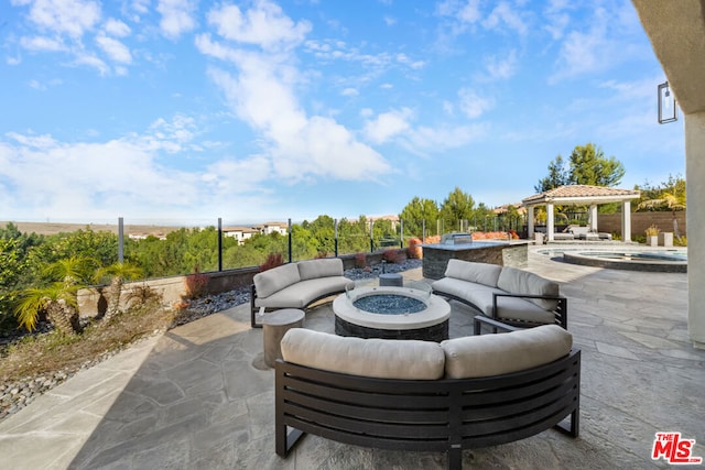 view of patio / terrace with a gazebo, an outdoor living space with a fire pit, and a pool with hot tub