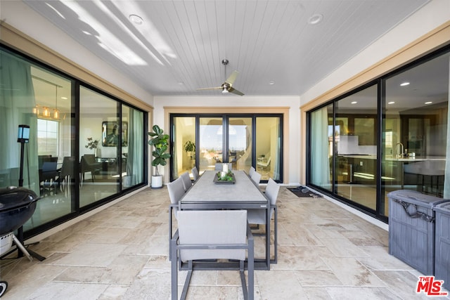 sunroom with ceiling fan and wood ceiling