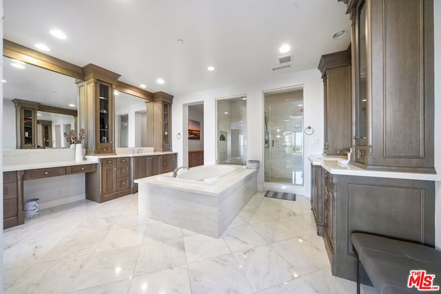 bathroom with decorative columns, shower with separate bathtub, and vanity