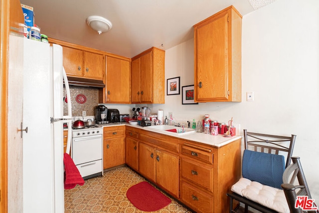 kitchen with decorative backsplash, sink, and white appliances