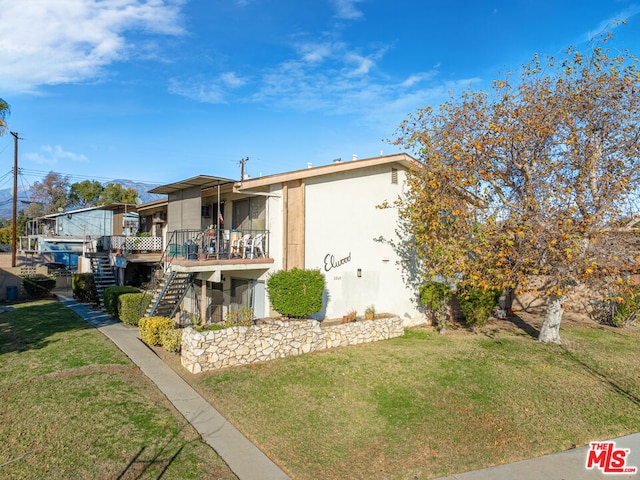 back of property featuring a lawn