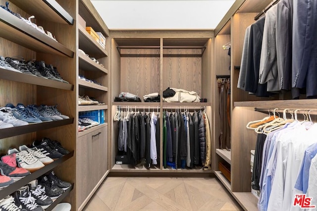 spacious closet with light parquet flooring