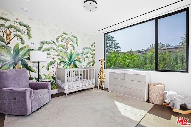 bedroom featuring a nursery area