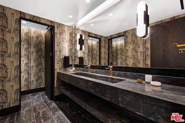 bathroom with vanity and wooden walls