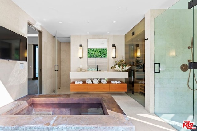 bathroom featuring an enclosed shower and vanity