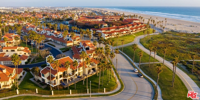 drone / aerial view featuring a beach view and a water view