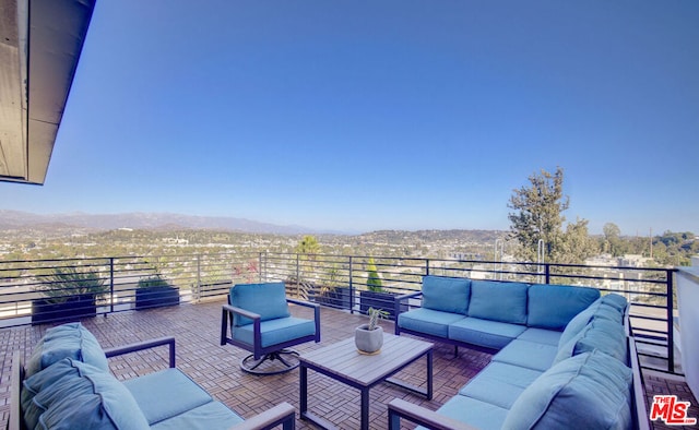 view of patio with a mountain view, an outdoor hangout area, and a balcony