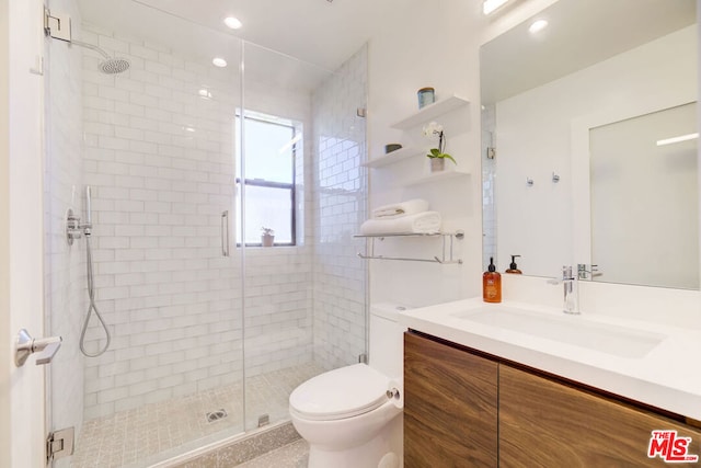 bathroom featuring vanity, toilet, and walk in shower