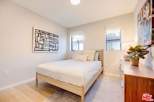 bedroom with hardwood / wood-style floors