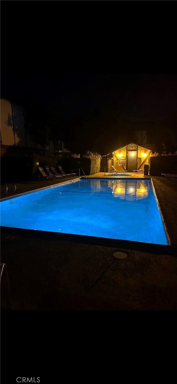 pool at night with an outdoor pool