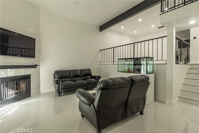 living room with recessed lighting, baseboards, a fireplace, and beamed ceiling