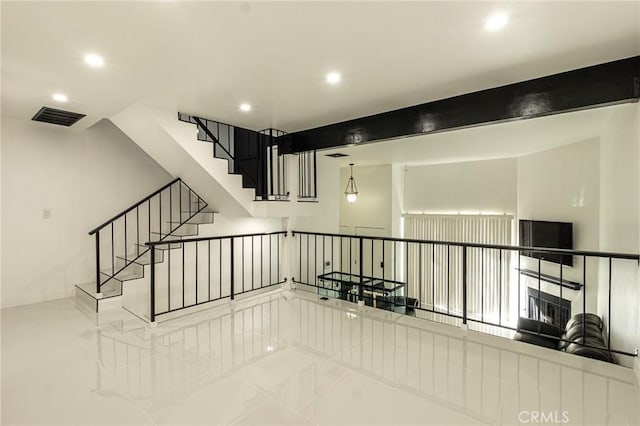 stairway featuring baseboards, visible vents, and recessed lighting