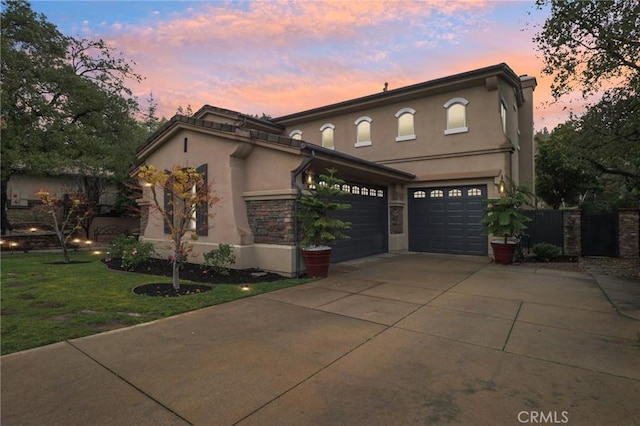 view of front facade with a garage and a lawn