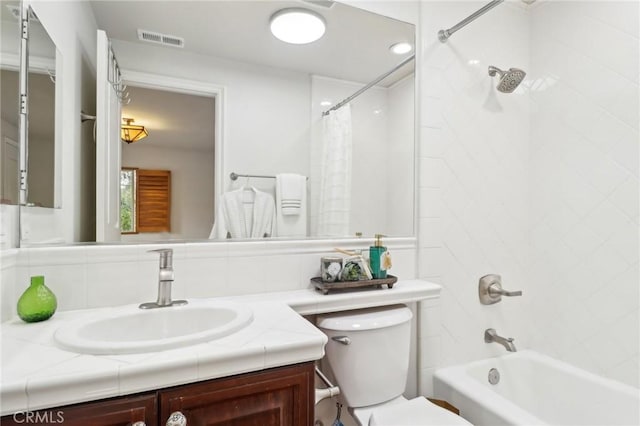 full bathroom with vanity, backsplash, shower / bath combination with curtain, and toilet