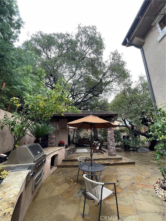 view of patio with a gazebo, area for grilling, and exterior kitchen