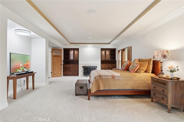 bedroom featuring light carpet and a tray ceiling