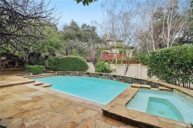 view of swimming pool featuring an in ground hot tub and a patio