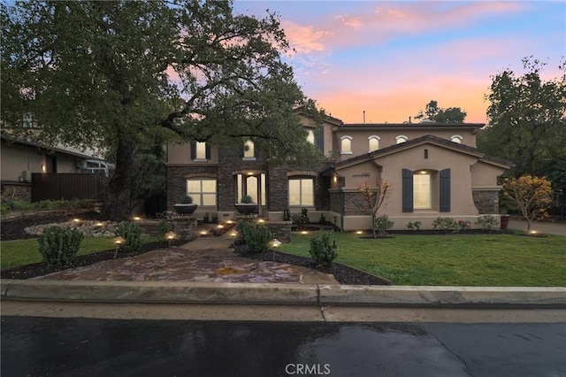 view of front of property with a lawn