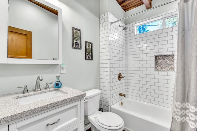 full bathroom featuring shower / tub combo with curtain, vanity, and toilet